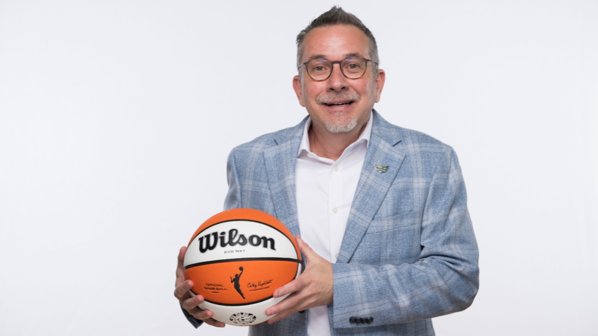 Dallas Wings general manager Curt Miller holds a Wilson WNBA game ball during 2026 Dallas Wings media day at College Park Center.