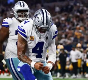 Dallas Cowboys quarterback Dak Prescott pumps his fist in celebration during a game against the Green Bay Packers