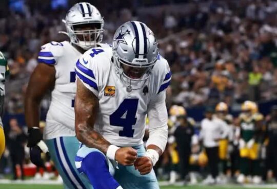 Dallas Cowboys quarterback Dak Prescott pumps his fist in celebration during a game against the Green Bay Packers