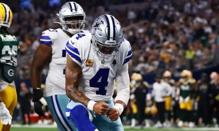 Dallas Cowboys quarterback Dak Prescott pumps his fist in celebration during a game against the Green Bay Packers