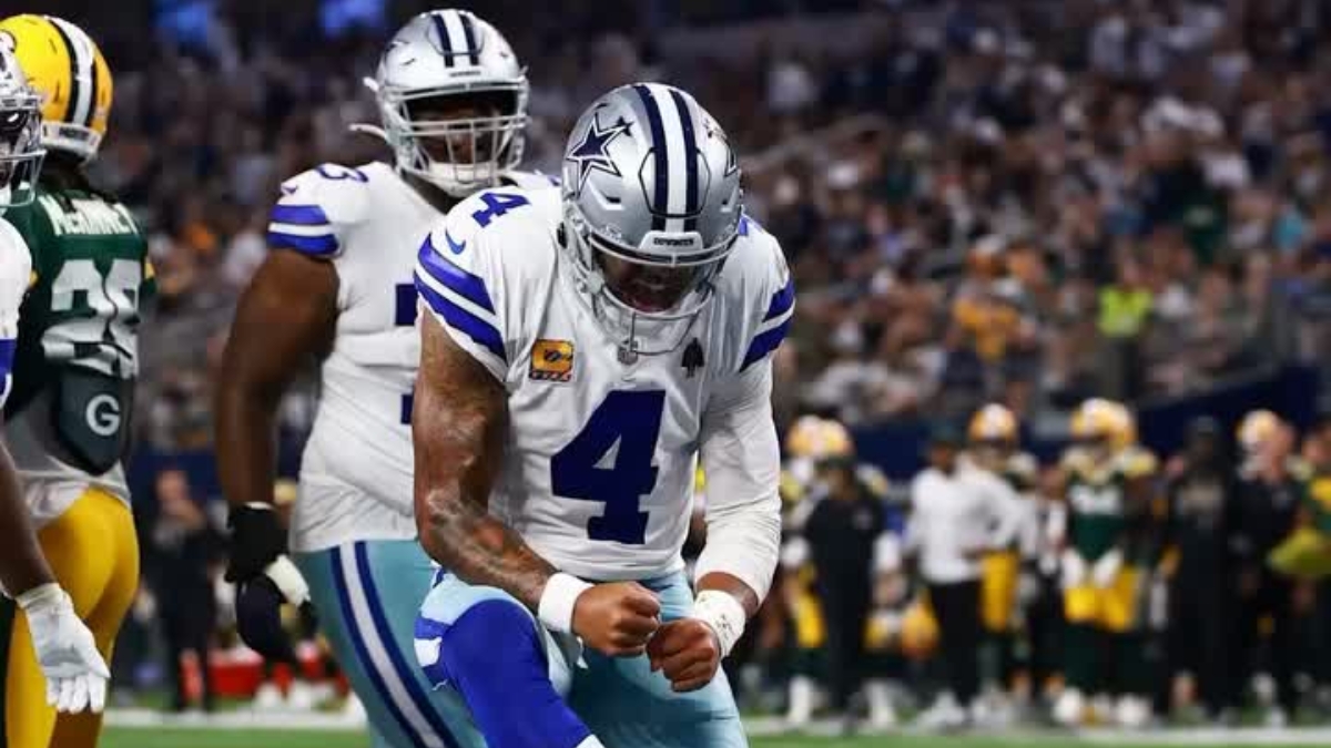 Dallas Cowboys quarterback Dak Prescott pumps his fist in celebration during a game against the Green Bay Packers
