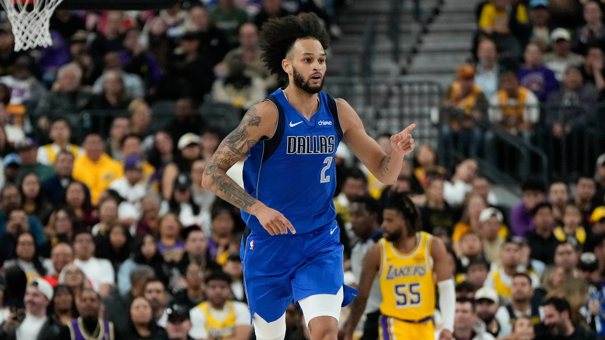 Dallas Mavericks center Dereck Lively II points downcourt after scoring against the Los Angeles Lakers.