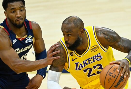 Cleveland Cavaliers guard Donovan Mitchell #45 defends Los Angeles Lakers forward LeBron James #23 during the fourth quarter at Rocket Arena.