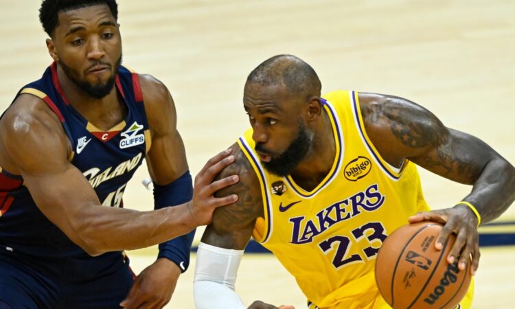 Cleveland Cavaliers guard Donovan Mitchell #45 defends Los Angeles Lakers forward LeBron James #23 during the fourth quarter at Rocket Arena.