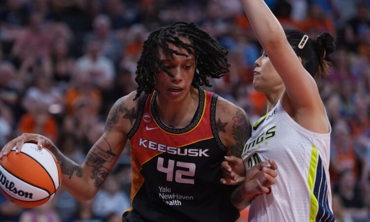 Connecticut Sun center Brittney Griner drives against Dallas Wings center Li Yueru in the second half at PeoplesBank Arena