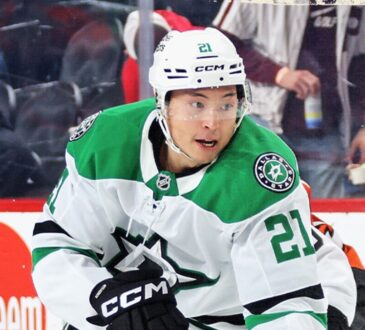 Dallas Stars left wing Jason Robertson (21) skates during a game, with an opposing player in an orange uniform nearby.