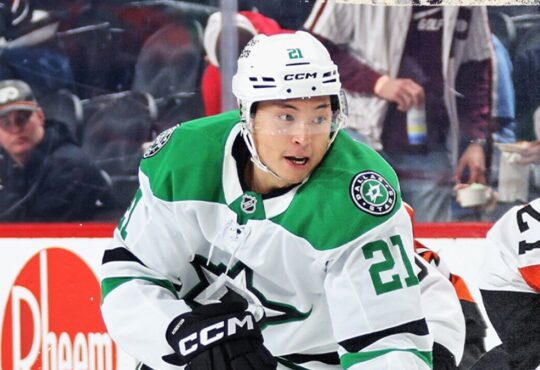 Dallas Stars left wing Jason Robertson (21) skates during a game, with an opposing player in an orange uniform nearby.