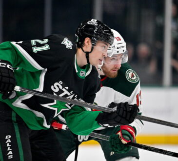 Dallas Stars left wing Jason Robertson and Minnesota Wild center Yakov Trenin skate stride for stride looking for the puck.