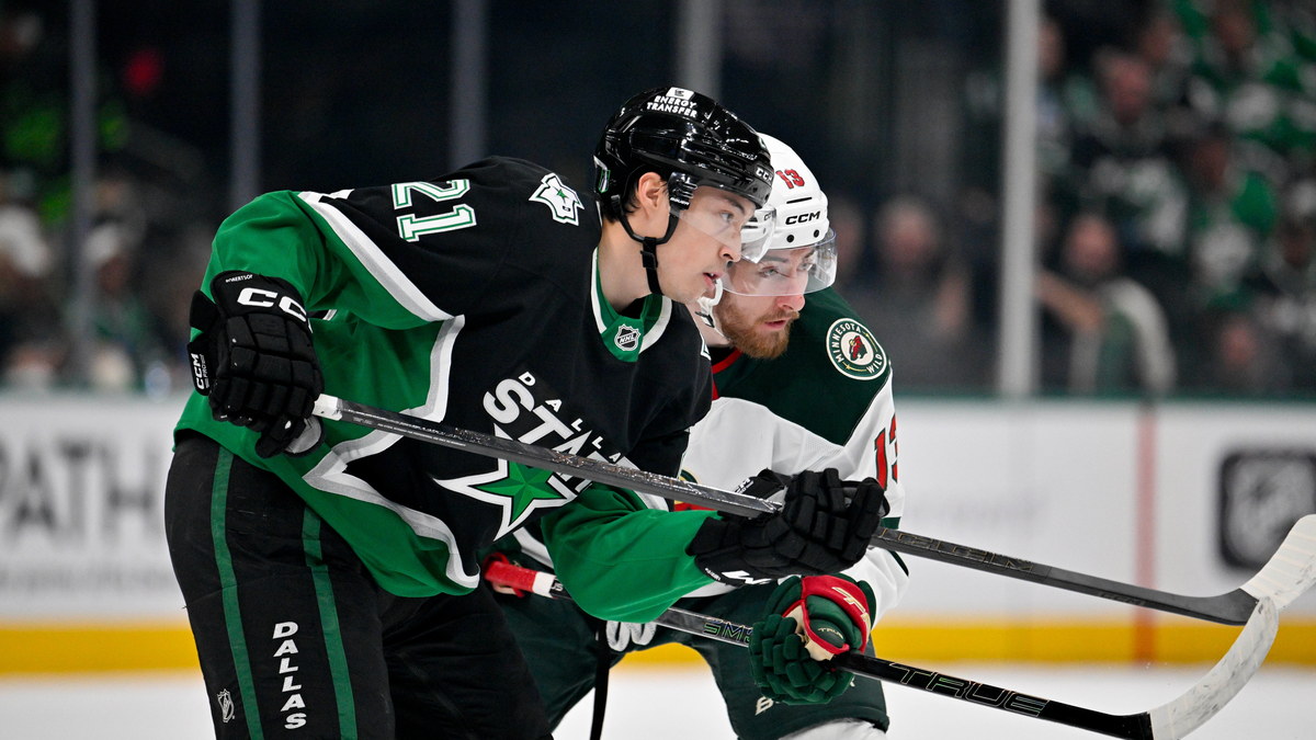 Dallas Stars left wing Jason Robertson and Minnesota Wild center Yakov Trenin skate stride for stride looking for the puck.