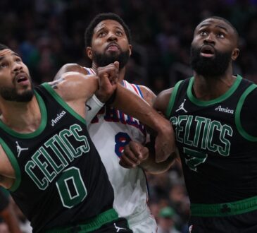 Jayson Tatum #0 and Jaylen Brown #7 of the Boston Celtics look for a rebound against Paul George #8 of the Philadelphia 76ers during Game 5 of the NBA Playoffs at TD Garden.