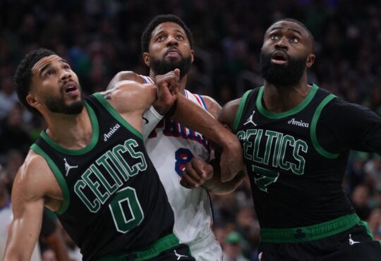 Jayson Tatum #0 and Jaylen Brown #7 of the Boston Celtics look for a rebound against Paul George #8 of the Philadelphia 76ers during Game 5 of the NBA Playoffs at TD Garden.