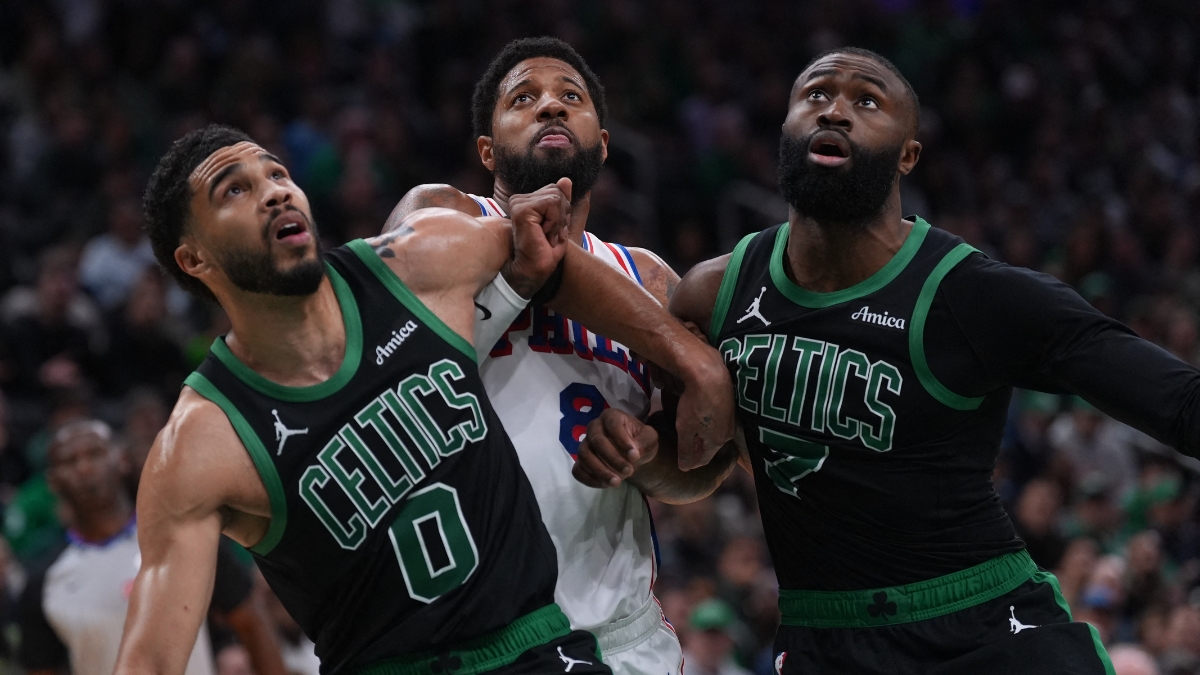 Jayson Tatum #0 and Jaylen Brown #7 of the Boston Celtics look for a rebound against Paul George #8 of the Philadelphia 76ers during Game 5 of the NBA Playoffs at TD Garden.
