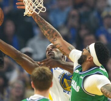 Golden State Warriors forward Jimmy Butler III shoots against Dallas Mavericks forward Anthony Davis during the first quarter on Christmas Day at Chase Center.