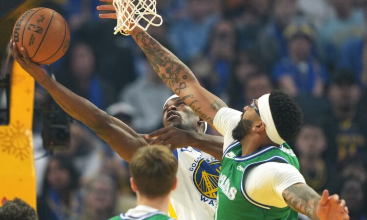 Golden State Warriors forward Jimmy Butler III shoots against Dallas Mavericks forward Anthony Davis during the first quarter on Christmas Day at Chase Center.