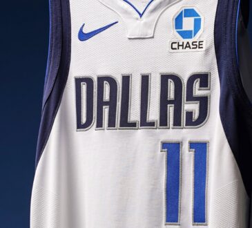 Close-up of a Dallas Mavericks white jersey showing the No. 11 and a new Chase logo patch on the left chest