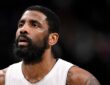Dallas Mavericks guard Kyrie Irving looks up while standing on the court during a game against the New Orleans Pelicans.