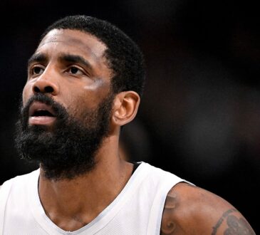 Dallas Mavericks guard Kyrie Irving looks up while standing on the court during a game against the New Orleans Pelicans.