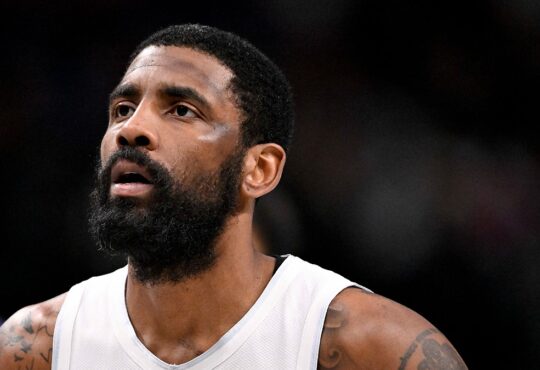 Dallas Mavericks guard Kyrie Irving looks up while standing on the court during a game against the New Orleans Pelicans.