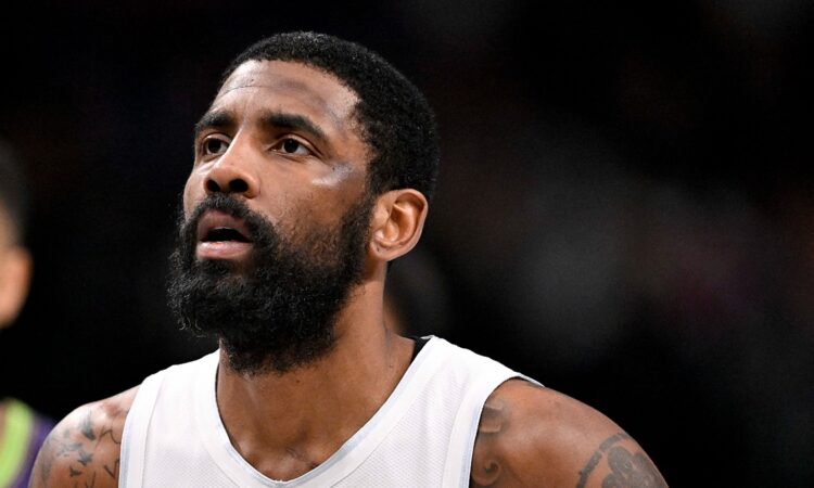 Dallas Mavericks guard Kyrie Irving looks up while standing on the court during a game against the New Orleans Pelicans.