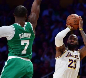 LeBron James of the Lakers shoots a jump shot over Jaylen Brown of the Celtics during a game at Crypto.com Arena