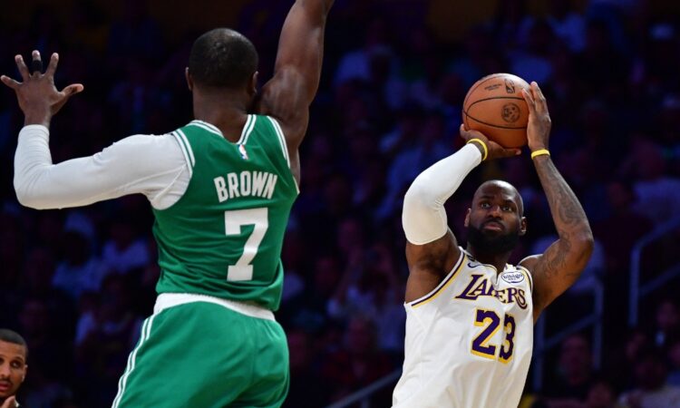 LeBron James of the Lakers shoots a jump shot over Jaylen Brown of the Celtics during a game at Crypto.com Arena