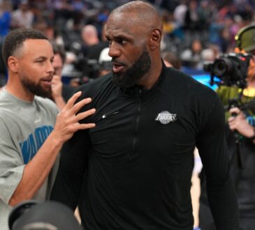 Los Angeles Lakers forward LeBron James #23 meets with Golden State Warriors guard Stephen Curry #30 after a game at Chase Center.