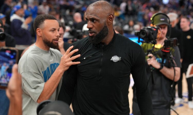 Los Angeles Lakers forward LeBron James #23 meets with Golden State Warriors guard Stephen Curry #30 after a game at Chase Center.
