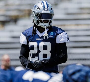 Dallas Cowboys safety Malik Hooker in a navy No. 28 practice jersey and helmet during a team practice