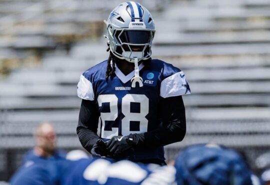 Dallas Cowboys safety Malik Hooker in a navy No. 28 practice jersey and helmet during a team practice