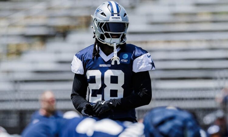 Dallas Cowboys safety Malik Hooker in a navy No. 28 practice jersey and helmet during a team practice