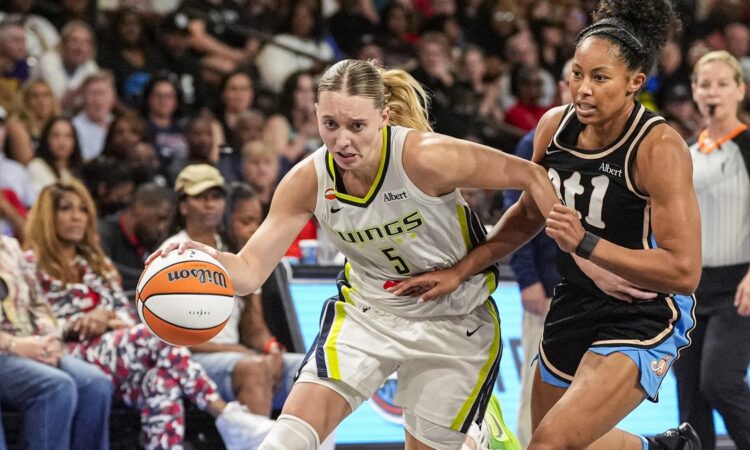 Dallas Wings guard Paige Bueckers drives past Atlanta Dream guard Indya Nivar at Gateway Center Arena in College Park