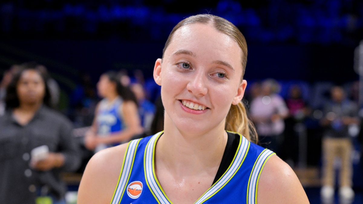 Dallas Wings guard Paige Bueckers smiles on the court at College Park Center after a game against the Las Vegas Aces.