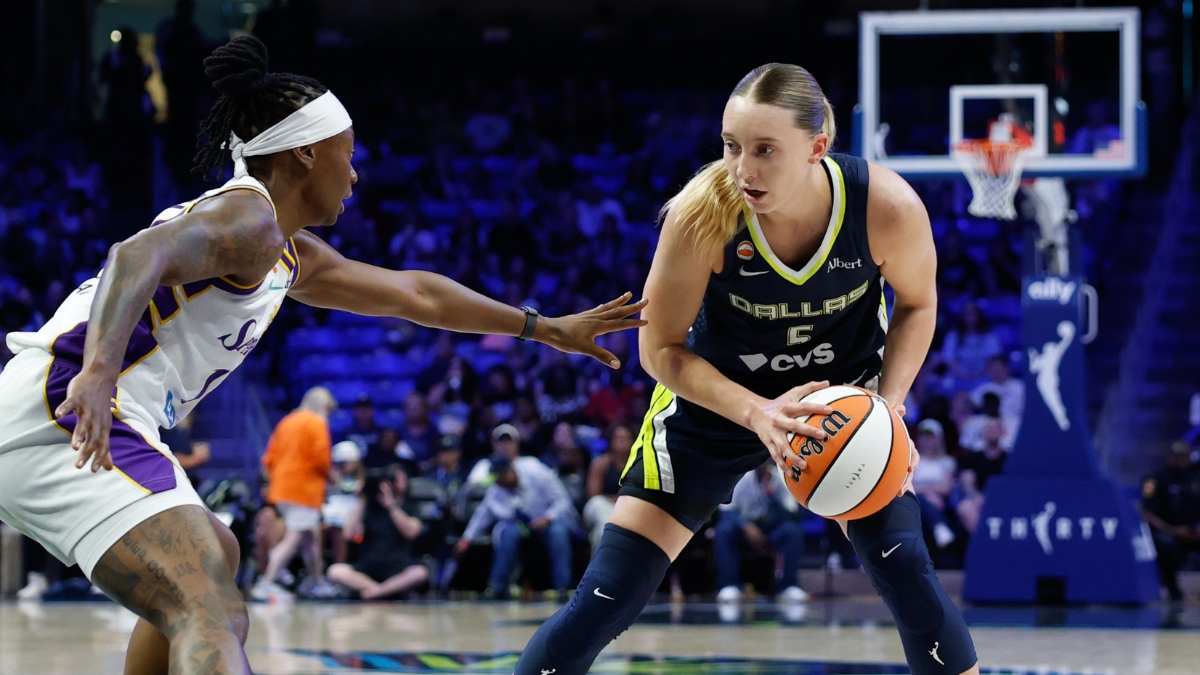 Dallas Wings guard Paige Bueckers controls the ball as Los Angeles Sparks guard Erica Wheeler defends during a game at College Park Center.