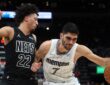 Memphis Grizzlies forward Santi Aldama drives to the basket against Brooklyn Nets forward Jalen Wilson during a game at FedExForum
