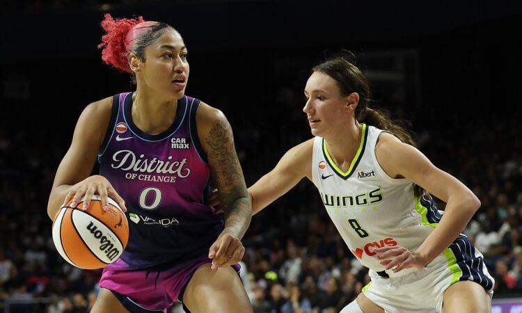 Dallas Wings forward Alanna Smith defends as Washington Mystics center Shakira Austin drives with the ball.
