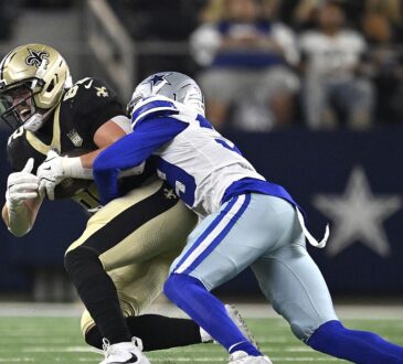 Dallas Cowboys cornerback Ameer Speed wraps up New Orleans Saints tight end Treyton Welch after a catch.
