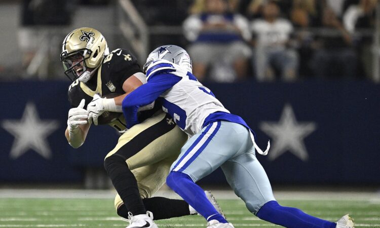 Dallas Cowboys cornerback Ameer Speed wraps up New Orleans Saints tight end Treyton Welch after a catch.