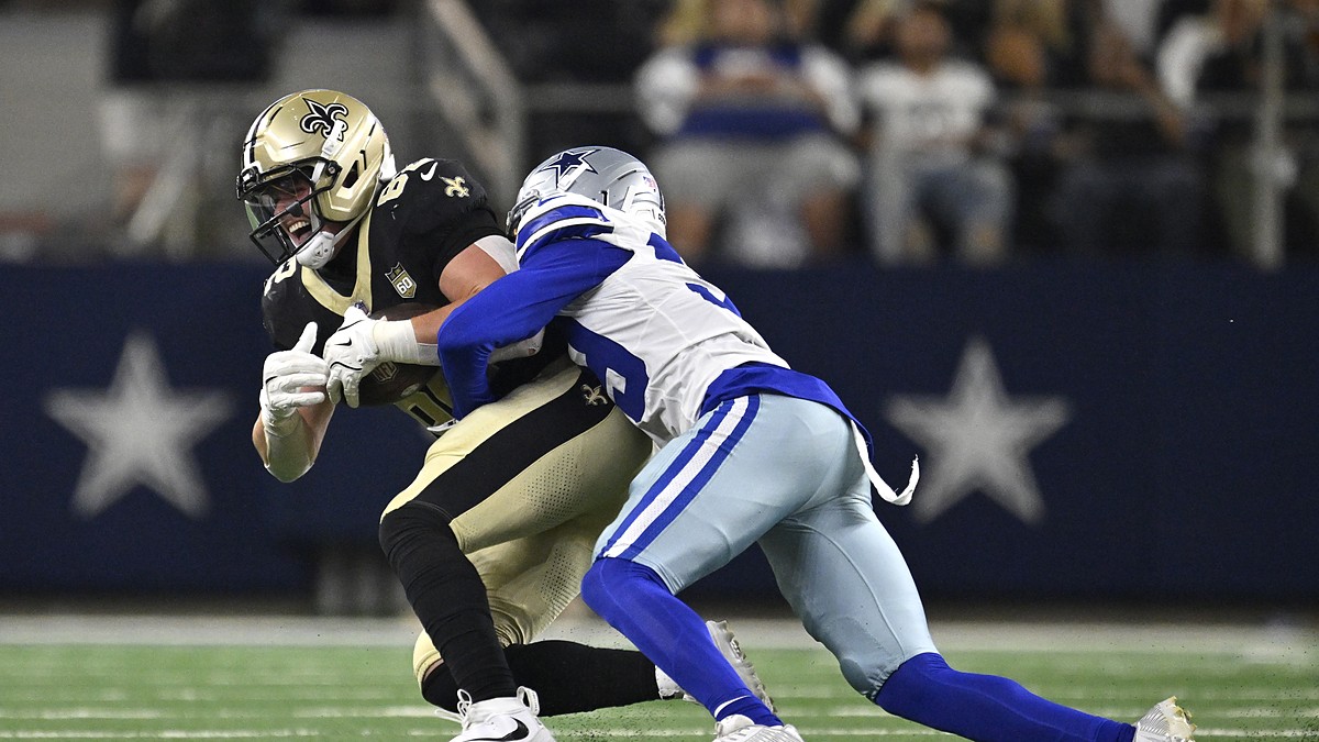 Dallas Cowboys cornerback Ameer Speed wraps up New Orleans Saints tight end Treyton Welch after a catch.