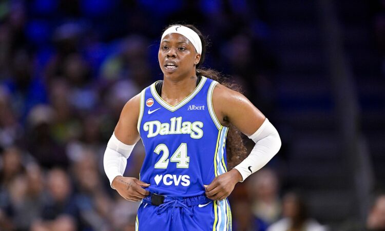 Dallas Wings guard Arike Ogunbowale stands with her hands on her hips during a stoppage against the Las Vegas Aces.