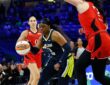 Dallas Wings guard Arike Ogunbowale drives the ball toward the basket past a Portland Fire defender.