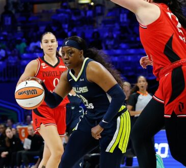 Dallas Wings guard Arike Ogunbowale drives the ball toward the basket past a Portland Fire defender.