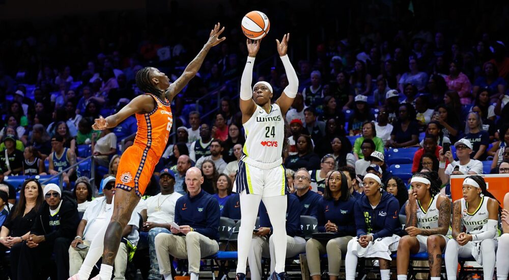 Dallas Wings guard Arike Ogunbowale rises for a three-point shot over a Connecticut Sun defender.