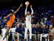 Dallas Wings guard Arike Ogunbowale rises for a three-point shot over a Connecticut Sun defender.