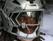Las Vegas Raiders running back Ashton Jeanty looks out from his helmet in the tunnel at Lincoln Financial Field.