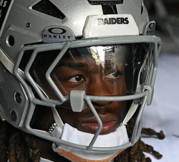 Las Vegas Raiders running back Ashton Jeanty looks out from his helmet in the tunnel at Lincoln Financial Field.