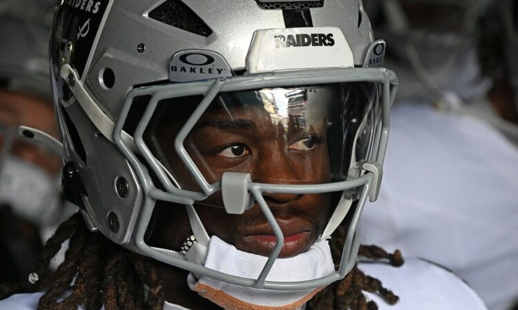 Las Vegas Raiders running back Ashton Jeanty looks out from his helmet in the tunnel at Lincoln Financial Field.