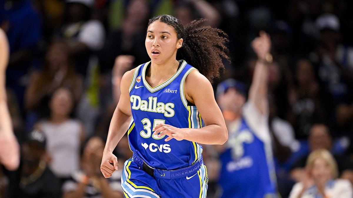Dallas Wings guard Azzi Fudd runs up the floor in a blue No. 35 Dallas jersey.