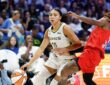 Dallas Wings guard Azzi Fudd drives to the basket on the dribble as Atlanta Dream guard Jaylyn Sherrod defends.