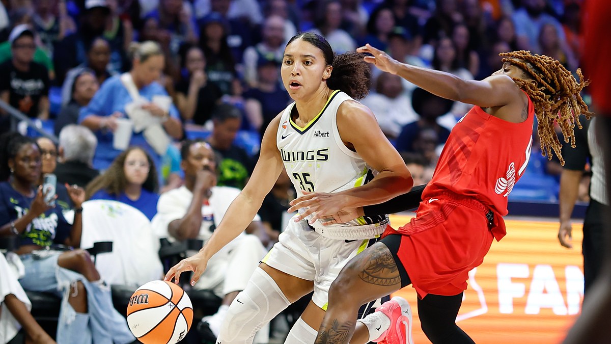 Dallas Wings guard Azzi Fudd drives to the basket on the dribble as Atlanta Dream guard Jaylyn Sherrod defends.