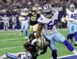 New Orleans Saints wide receiver Barion Brown pulls in a touchdown catch as Cowboys cornerback Caelen Carson falls beneath him.